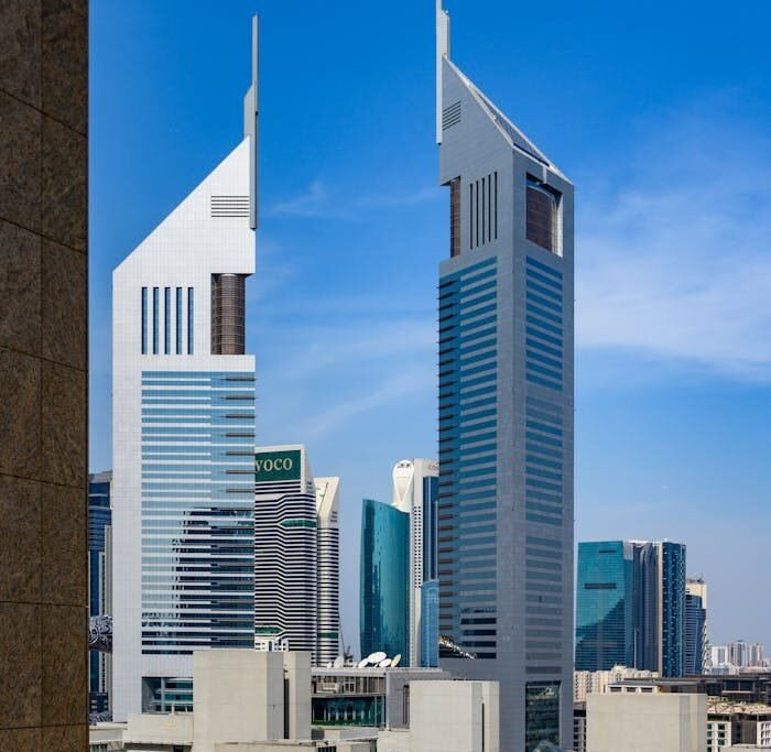 Striking view of the Emirates Towers in Dubai against a clear blue sky, highlighting modern architecture.